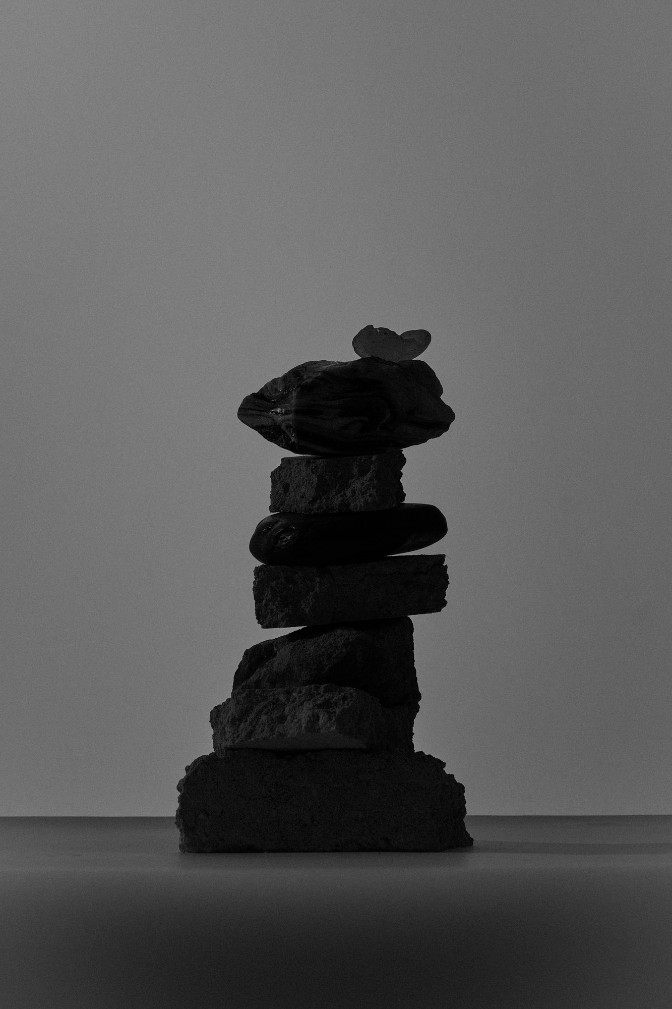 Stacked stones against a grey ground